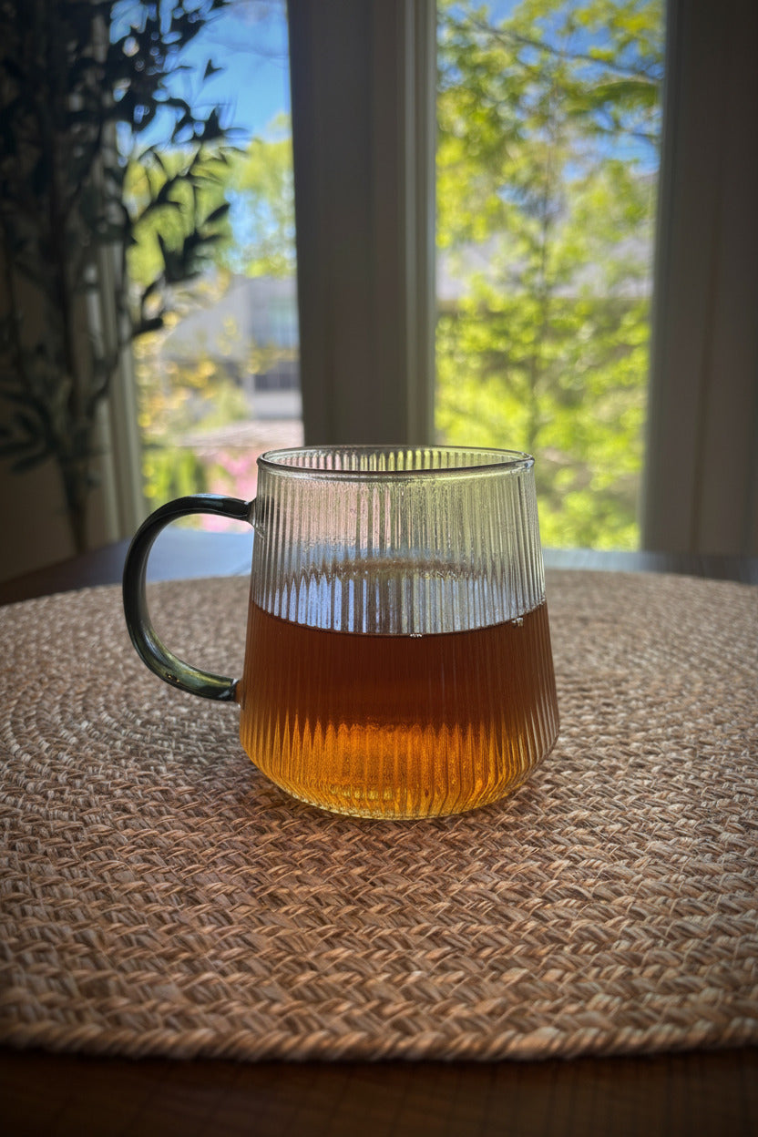 glass cup containing amber tea infusion