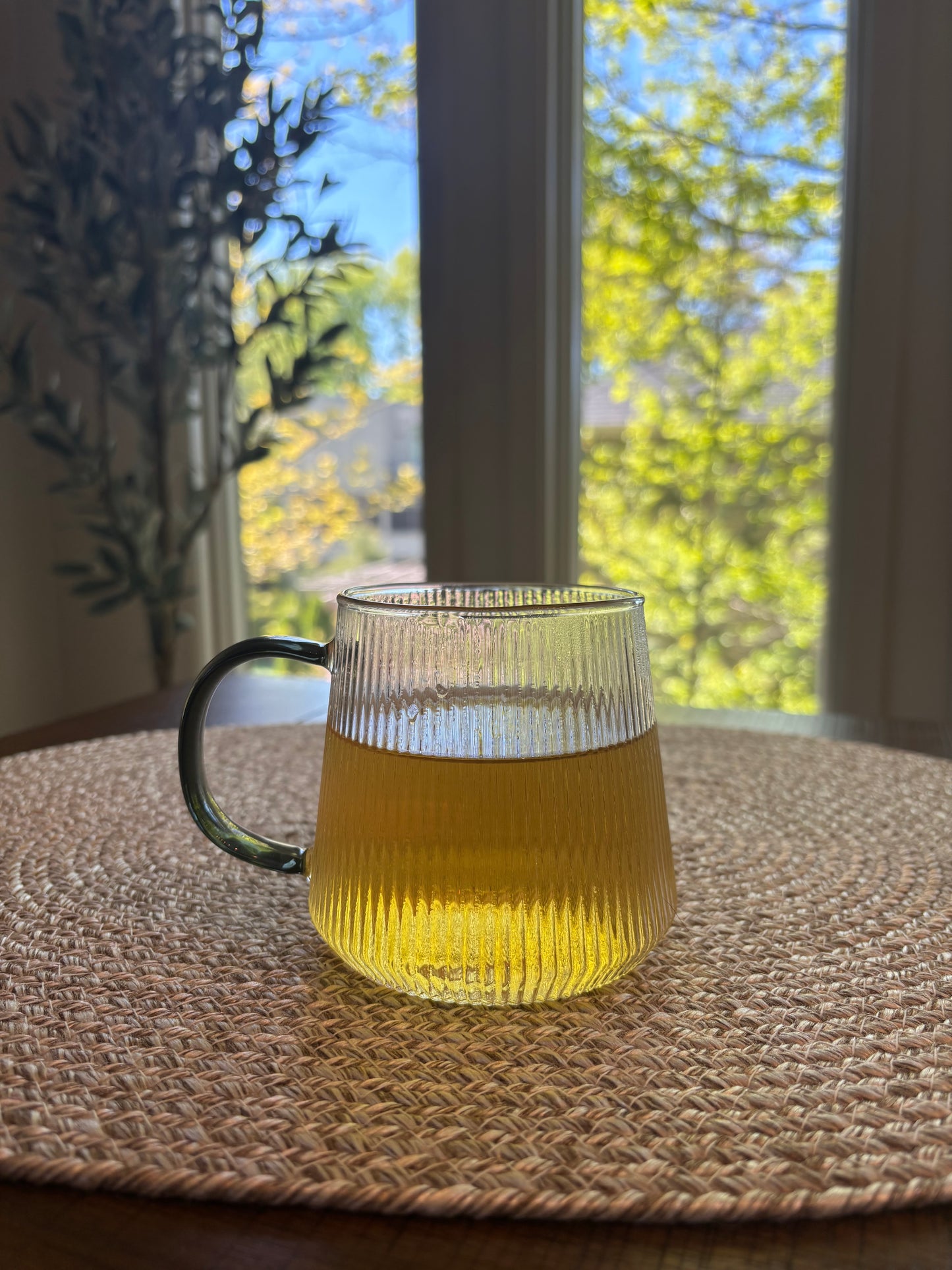 glass cup with pale green yellow liquid