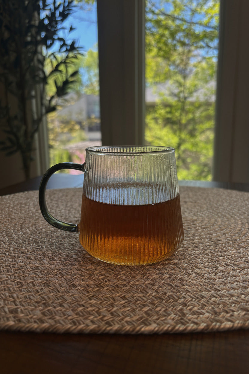 glass cup contain tea with warm amber tones